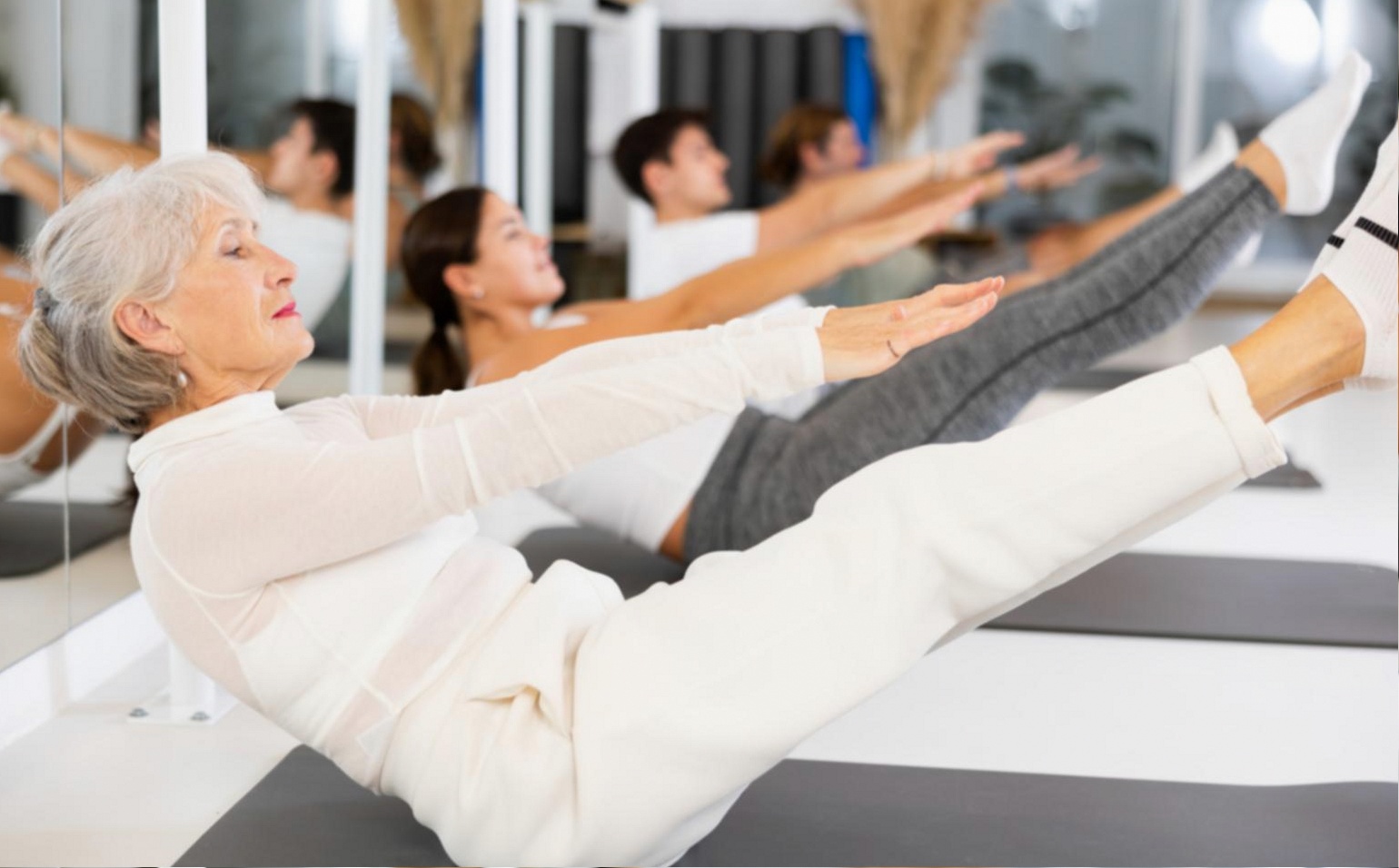 Hatha yoga group session in progress, participants in seated posture